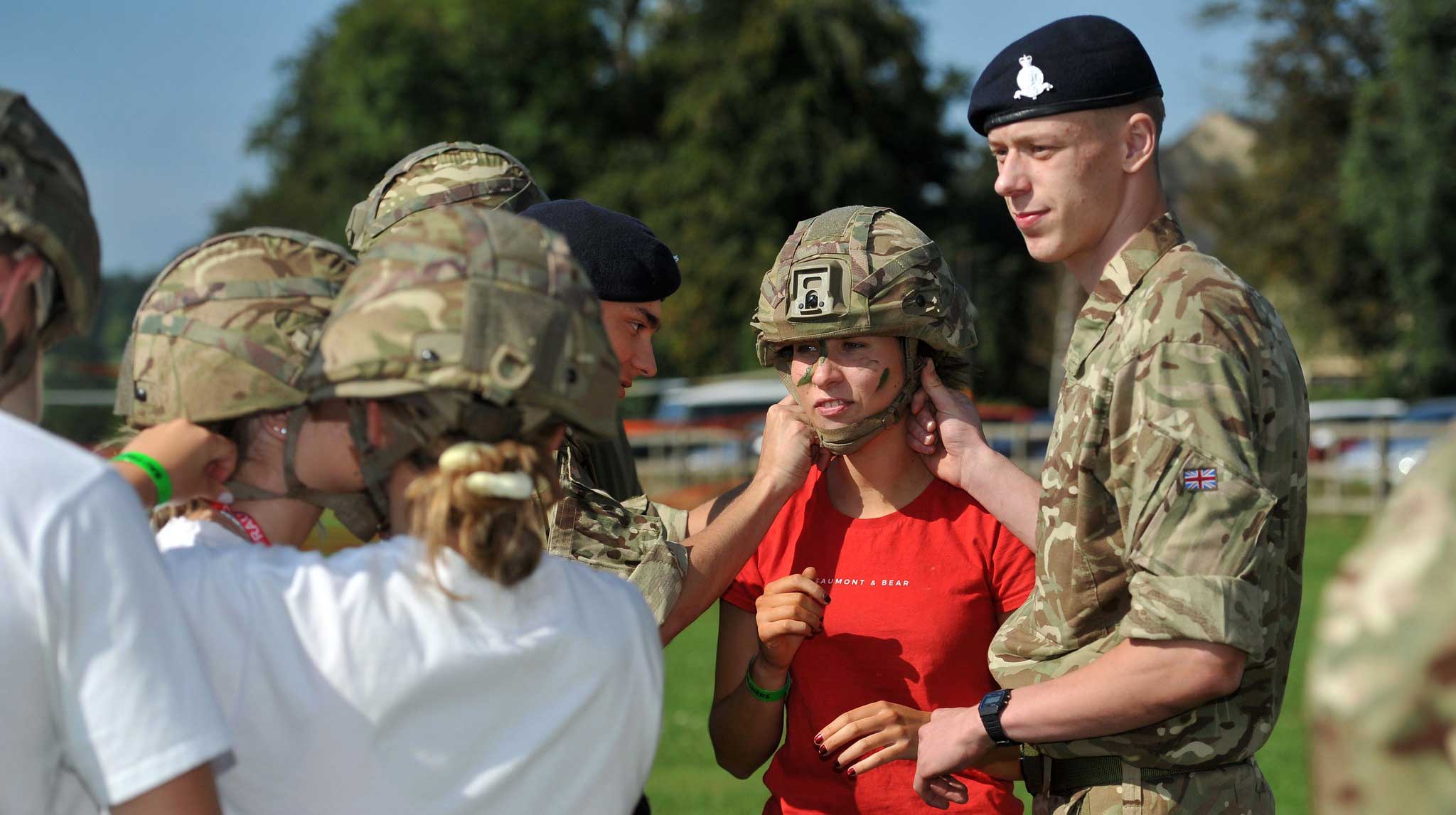 Armed forces person with students