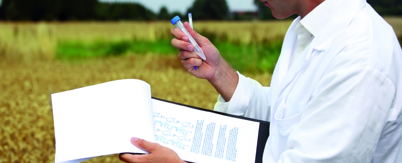 Student in field with sample and clipboard