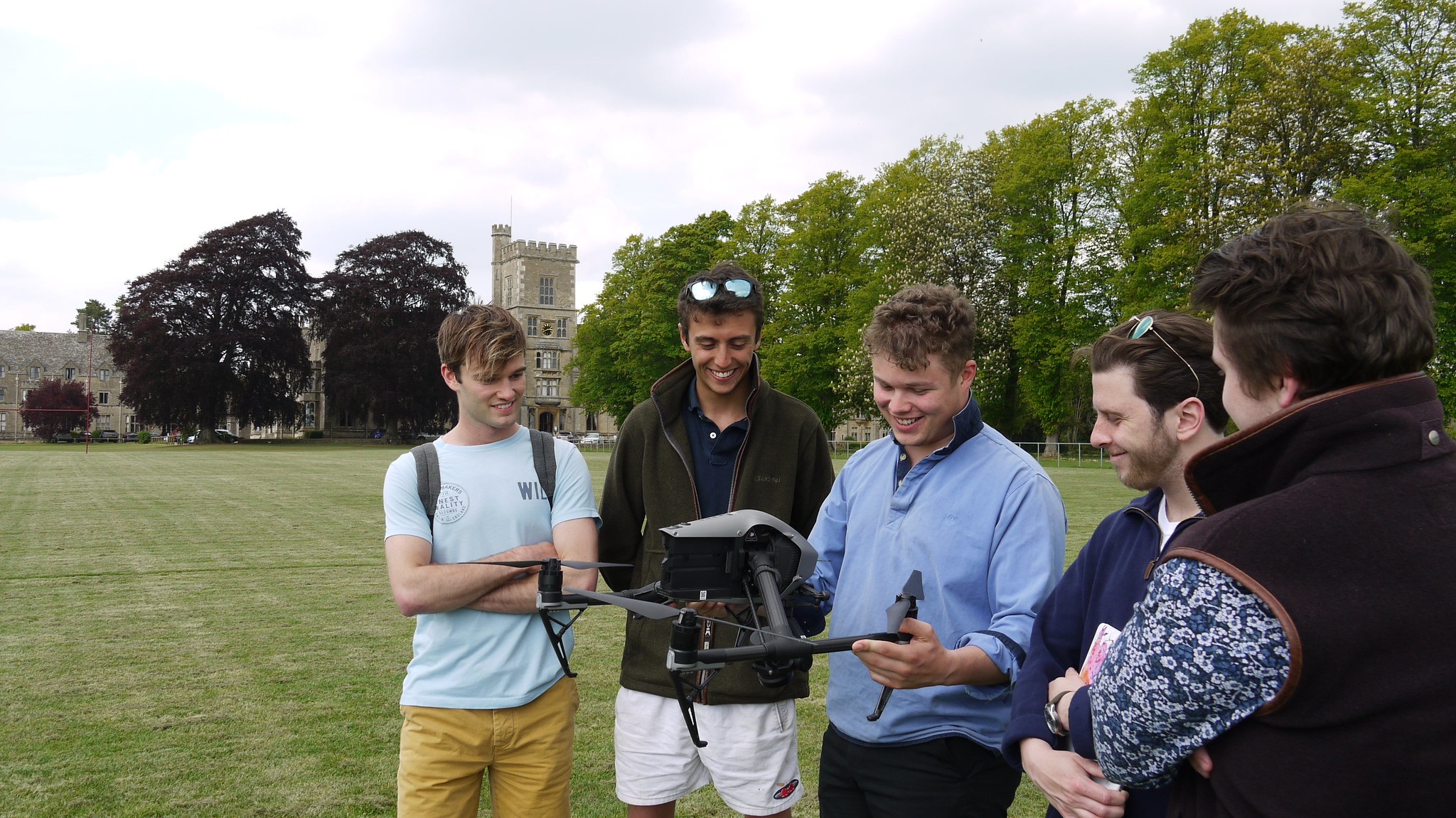 Students holding a drone