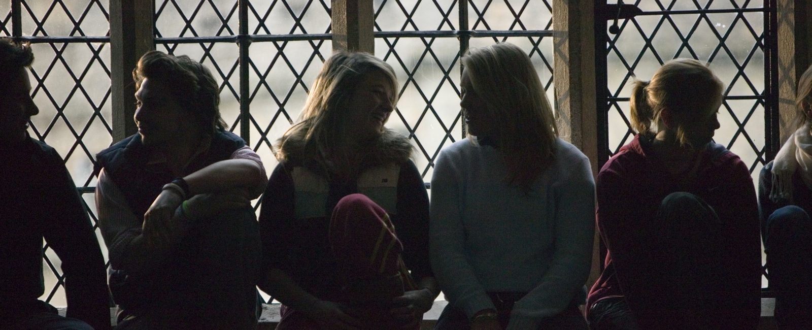 Students sitting in window talking
