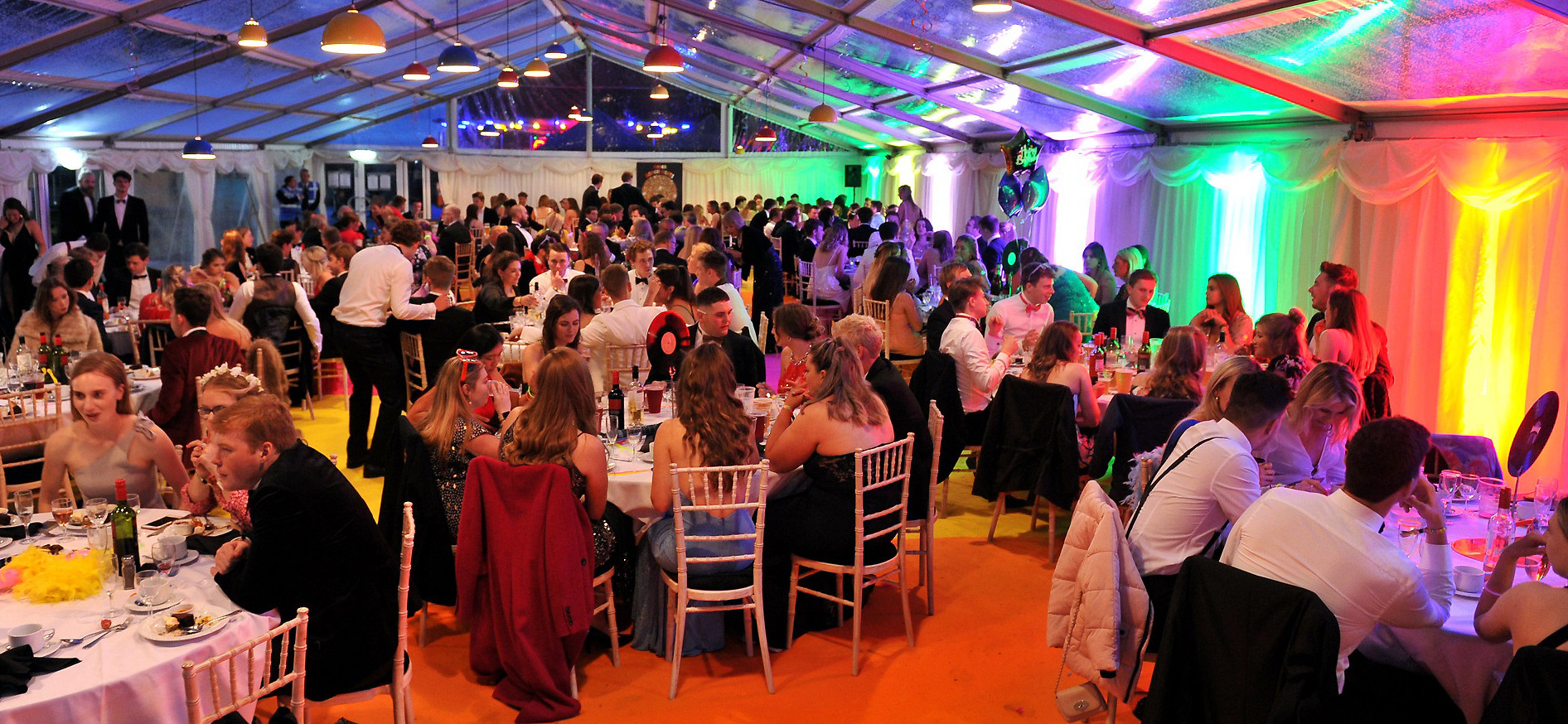 Students having formal meal at summer ball