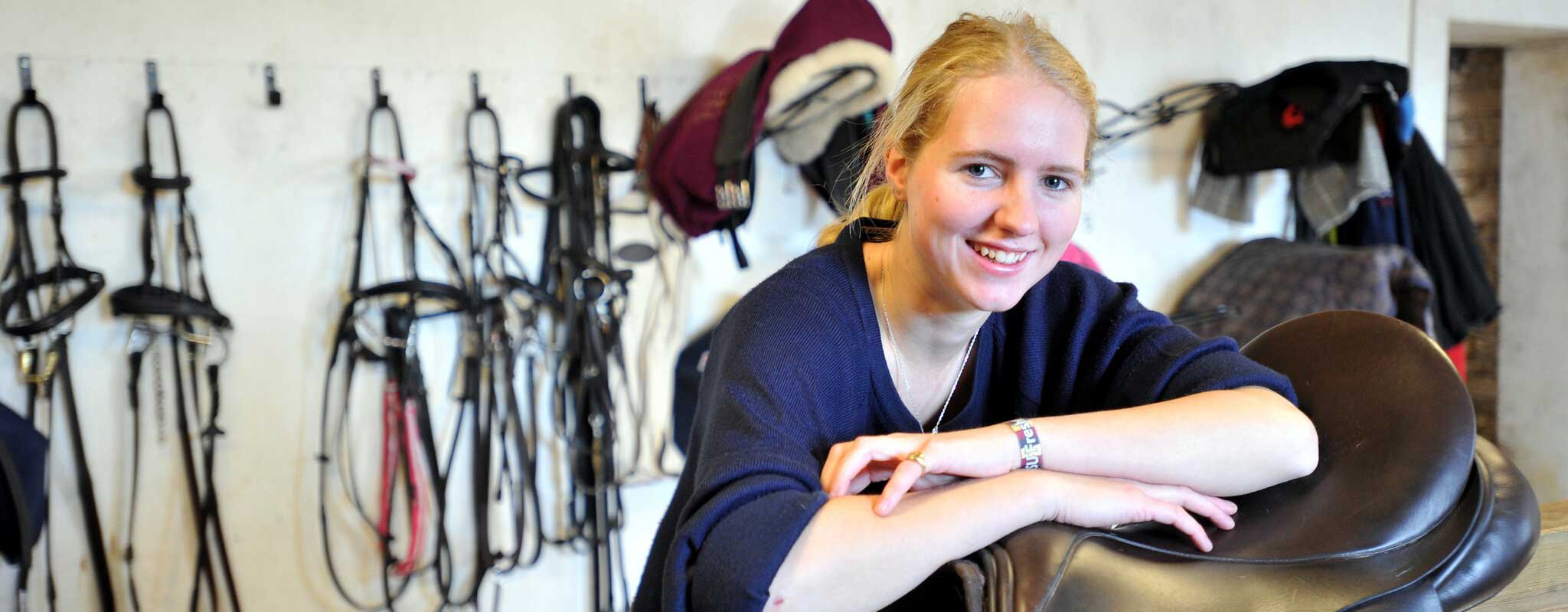 Equine student in tackroom