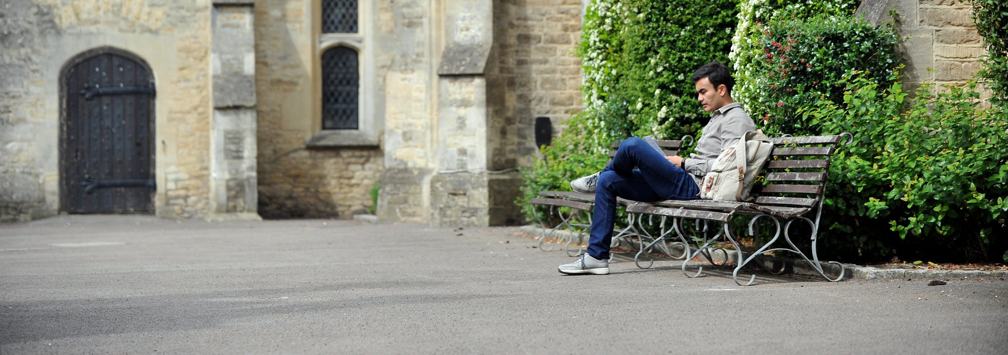 Man on bench on campus
