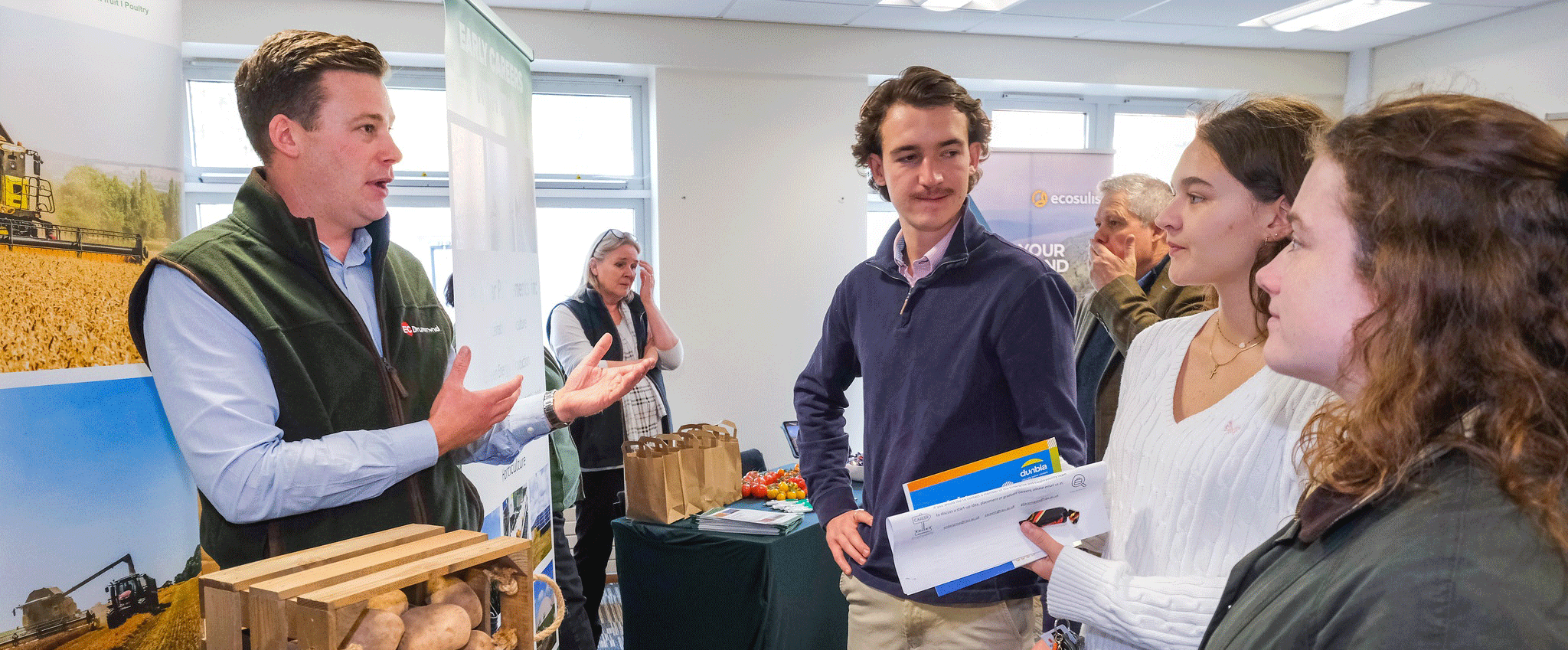 students talking to a potential employer