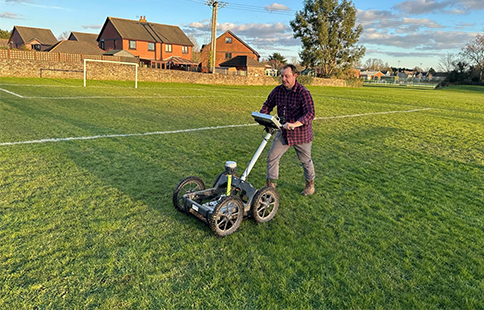 Henry Webber using ground survey equipment