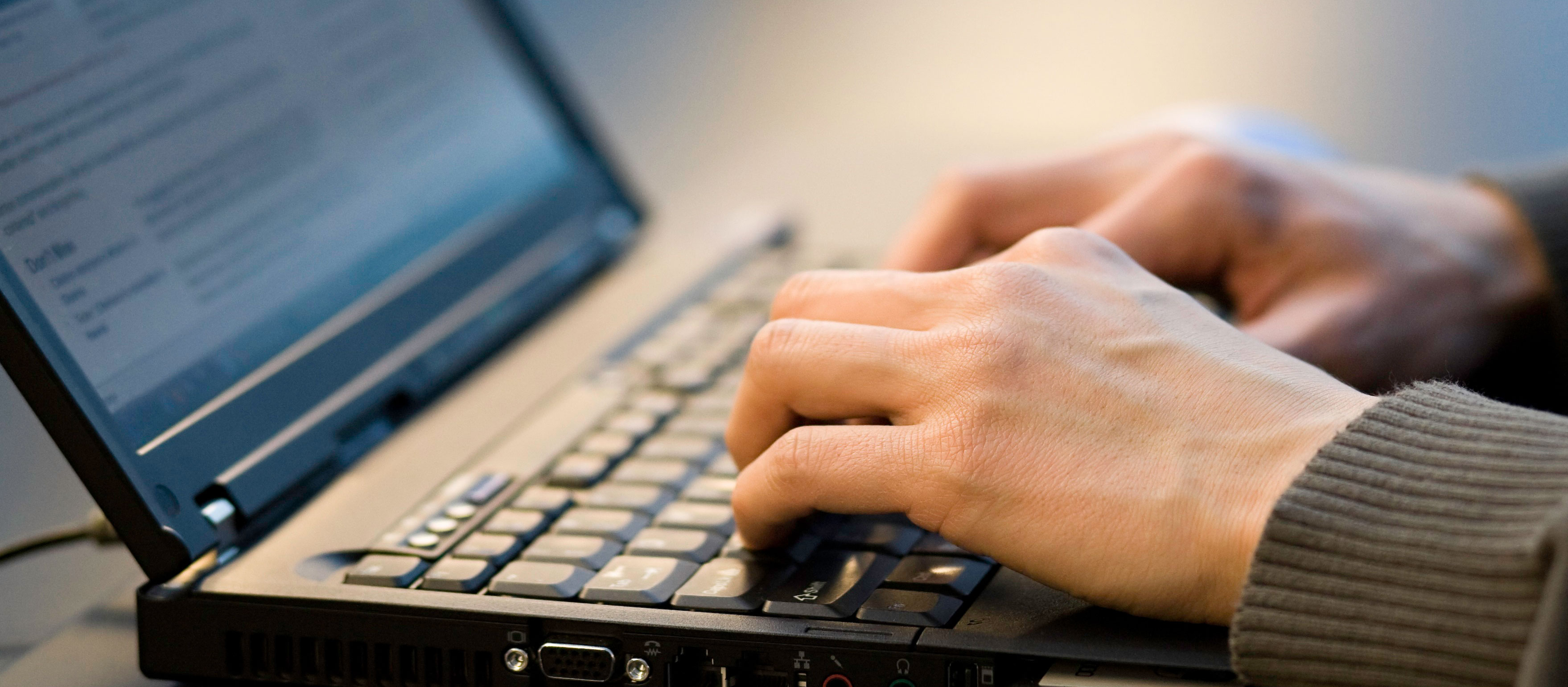 Person typing on a laptop