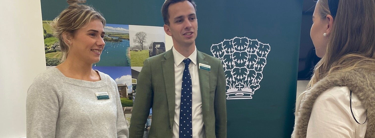 male and female talking to female student at a careers fair