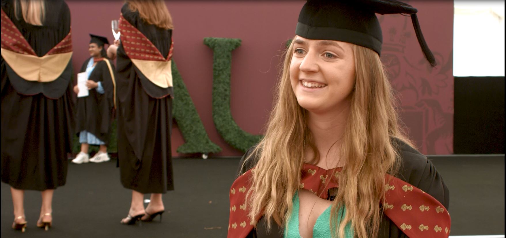 A student in graduation robes