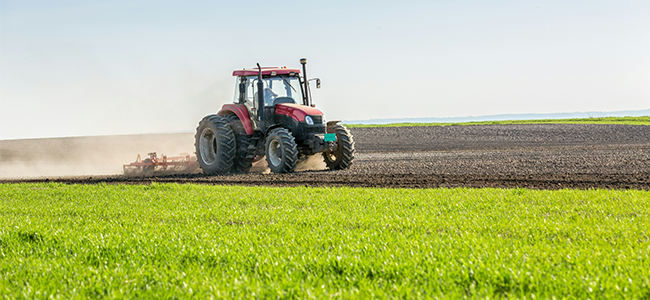 Tractor cultivating arable land