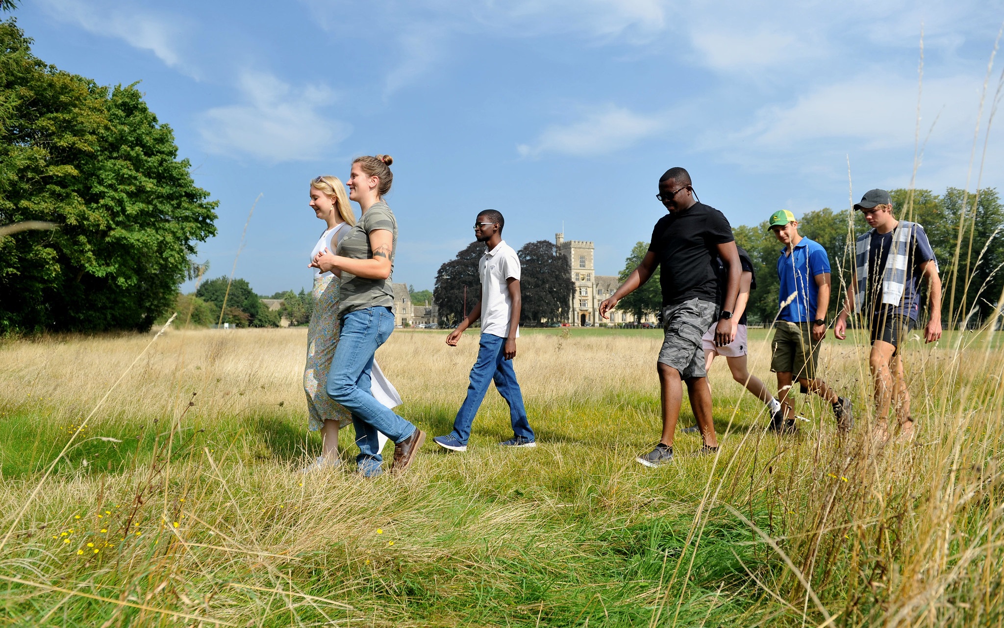 Group of international students walking across a field