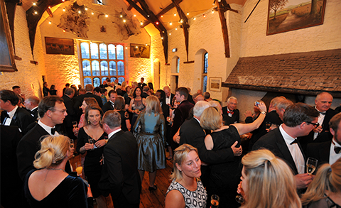 A group of people at a social event inside Tithe Barn