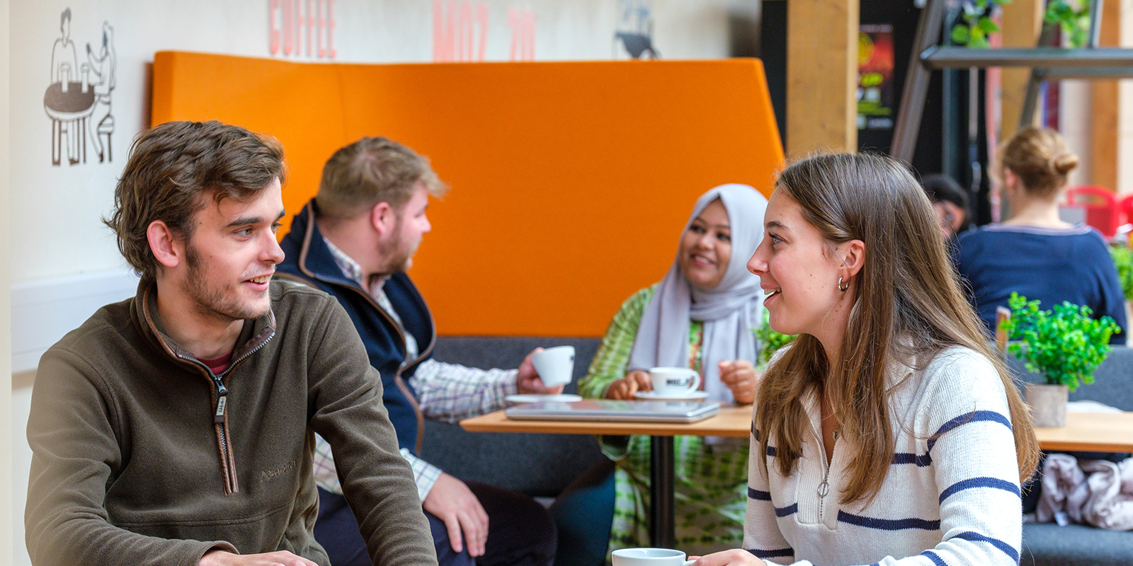 Students sitting in a cafe chatting