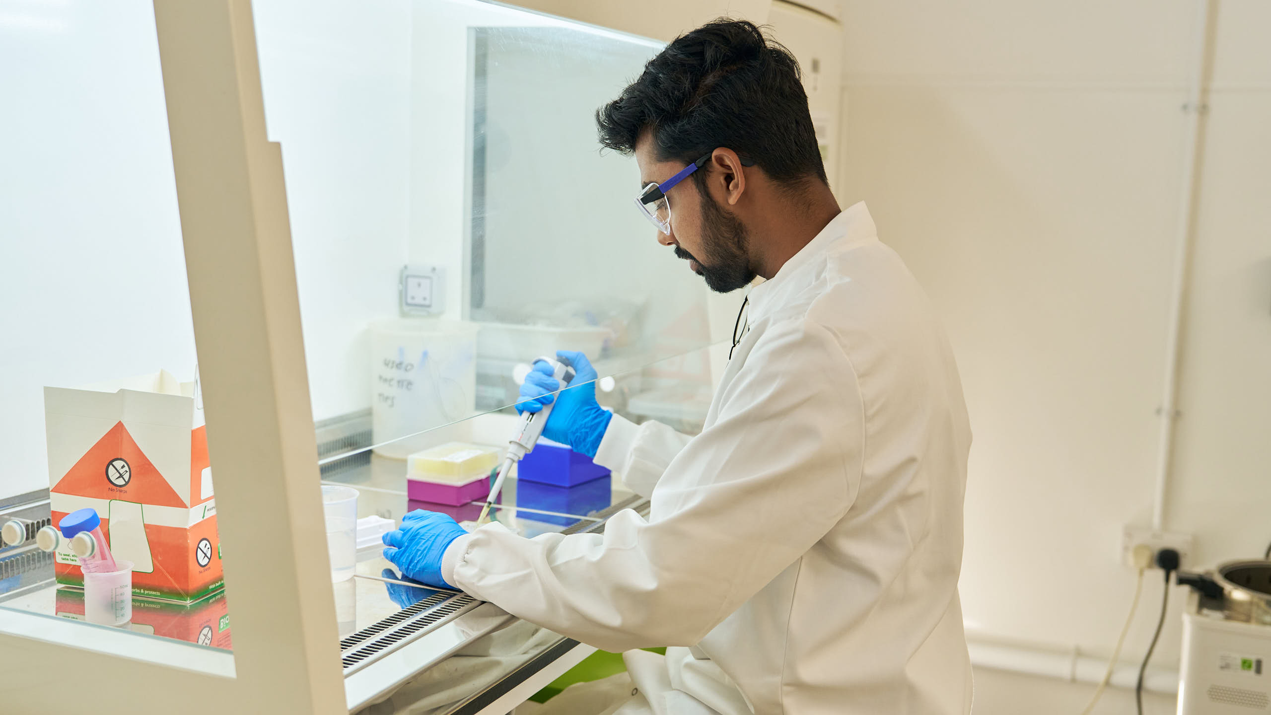 Researcher experimenting in microbiology laboratory