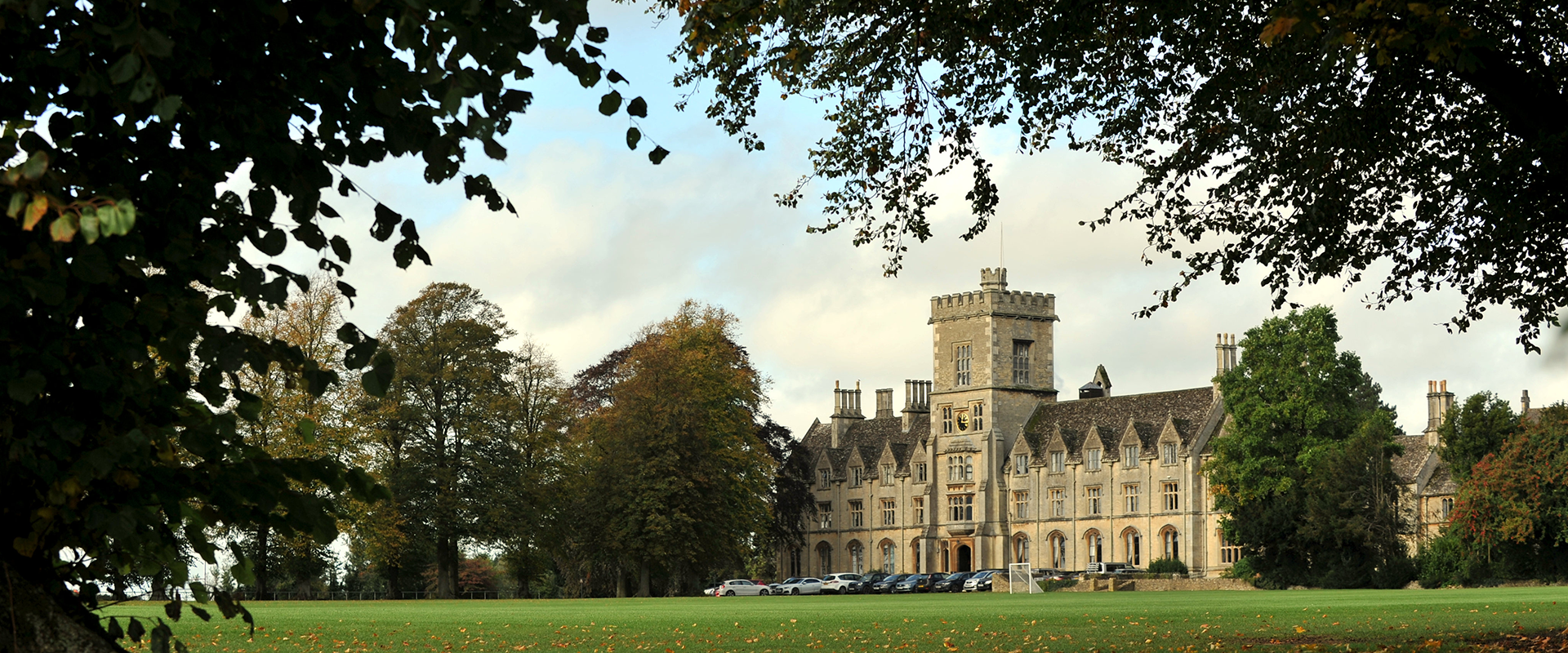 Royal Agricultural University main building front view from under trees