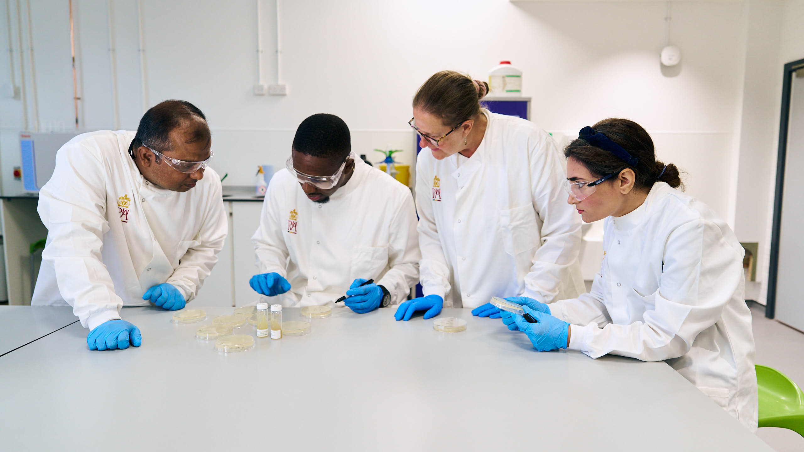 students and staff member in microbiology laboratory