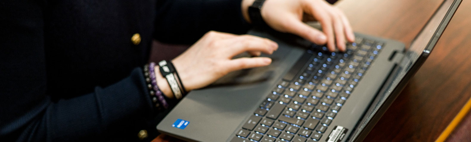 someone typing on a laptop keyboard