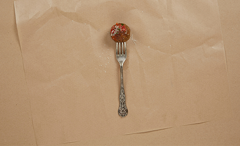 A cultivated meatball on a fork