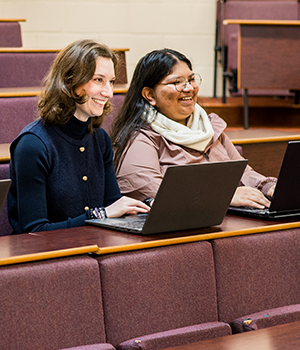 Two students in a lecture hall