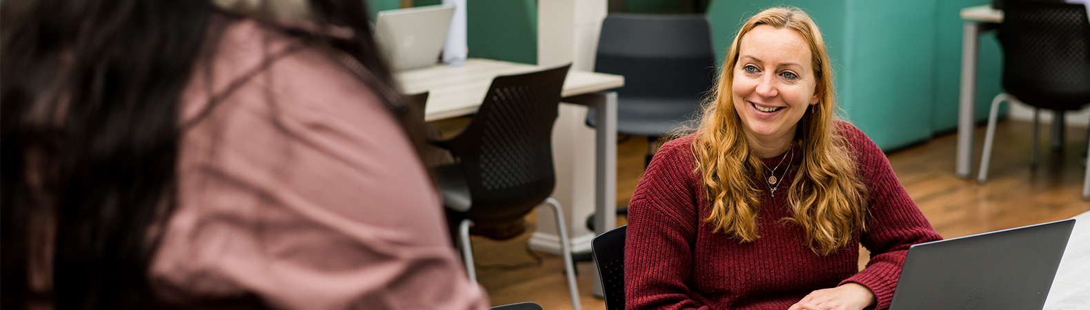 A member of staff talking to a student