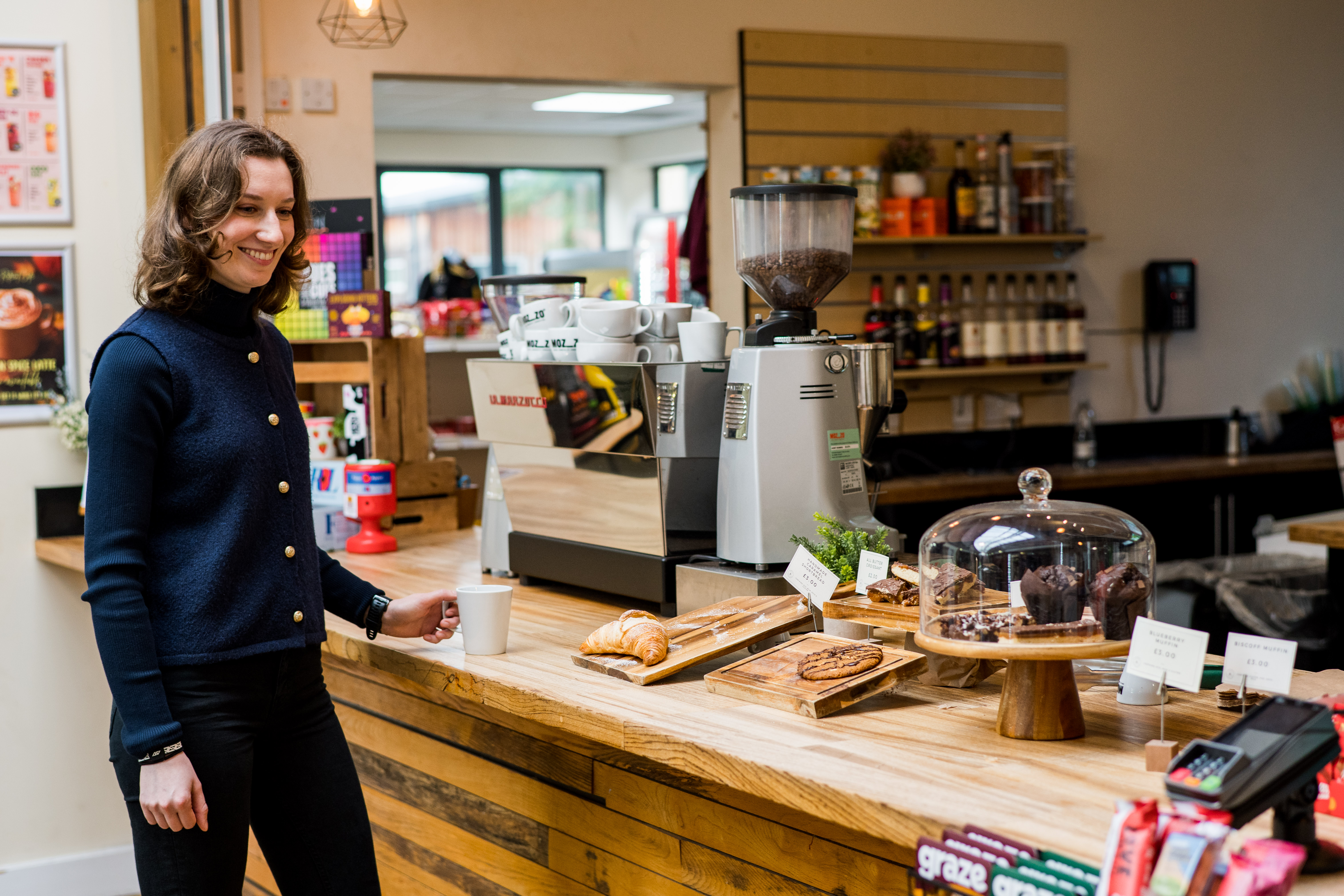A person stood at the counter in the Retreat Cafe