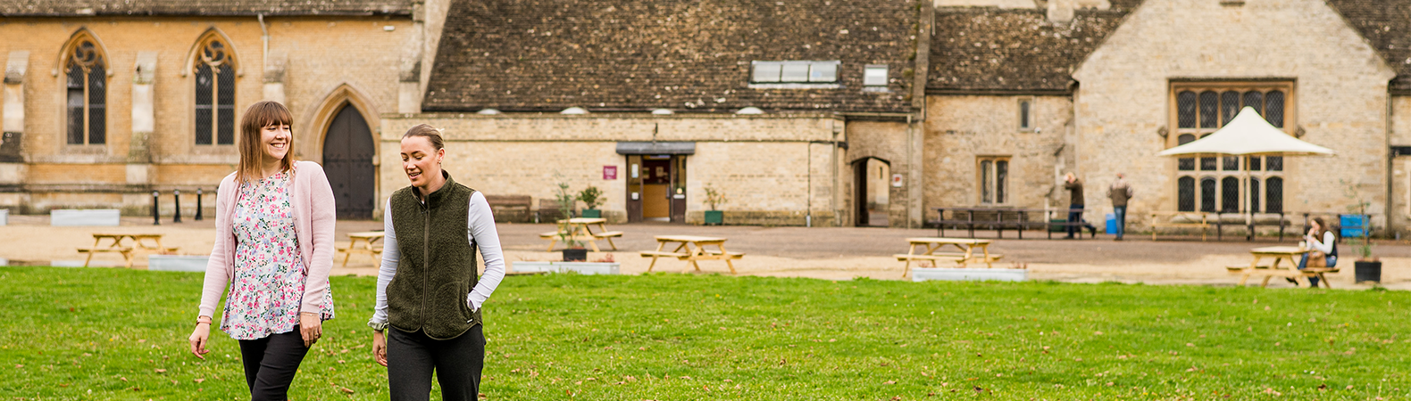 Two people walking across campus