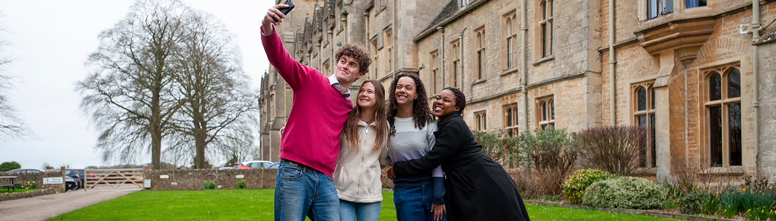 A group of students taking a selfie in front of the main RAU building