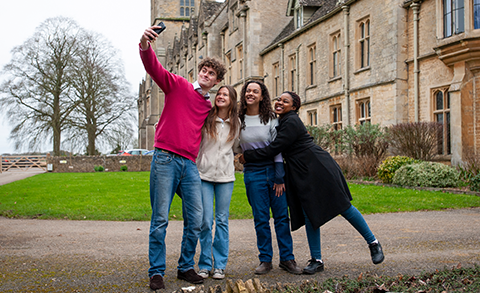 Students taking a selfie outside the RAU main building