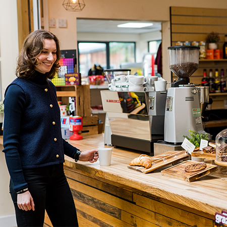 A person stood at the counter in the Retreat Cafe