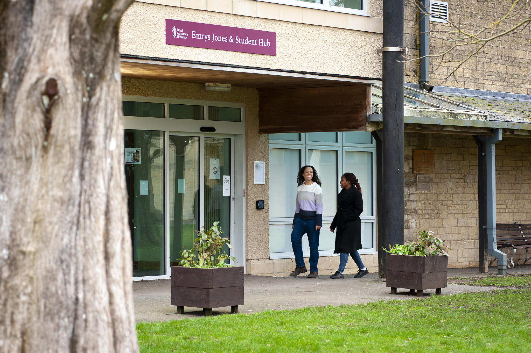 two students walking by a lecture block