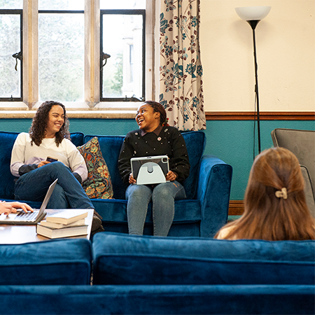 students chatting, sat on a sofa