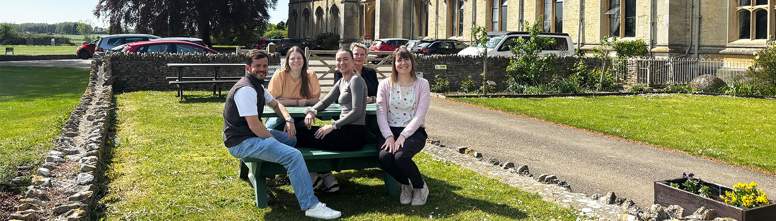 Members of the Student Recruitment team sat at a picnic table