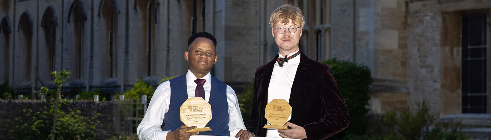 Grand Idea competition winner Ian Muthumbi and runner up Lewis Jackson, holding their awards and a large presentation cheque