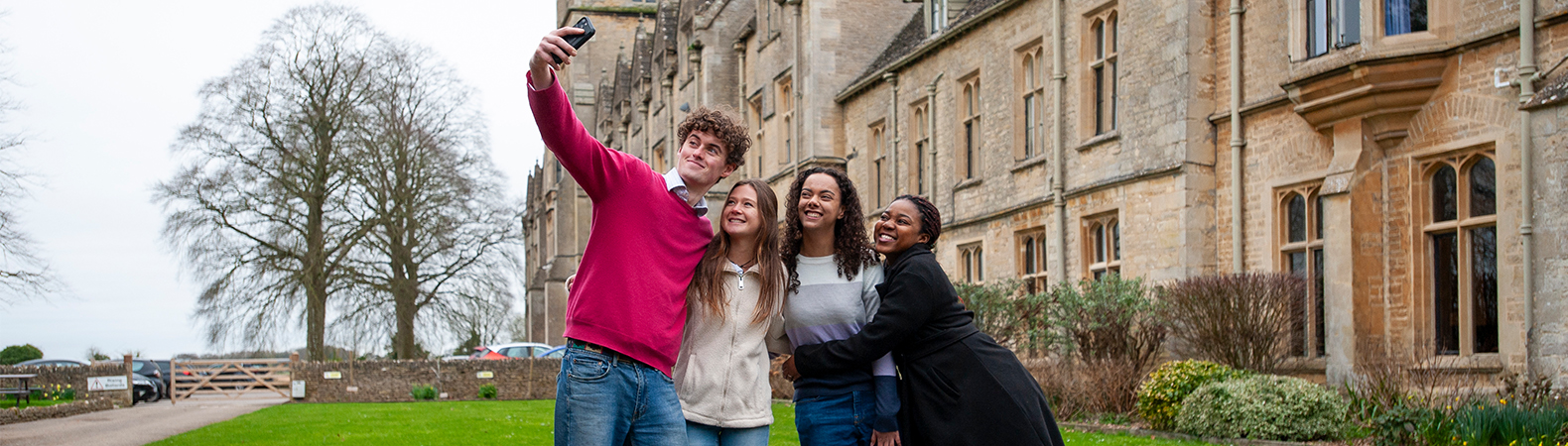 A group of students taking a selfie outside the main RAU building