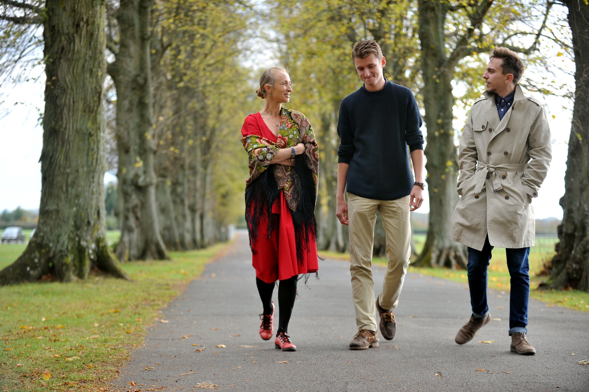 Three students walking on the driveway