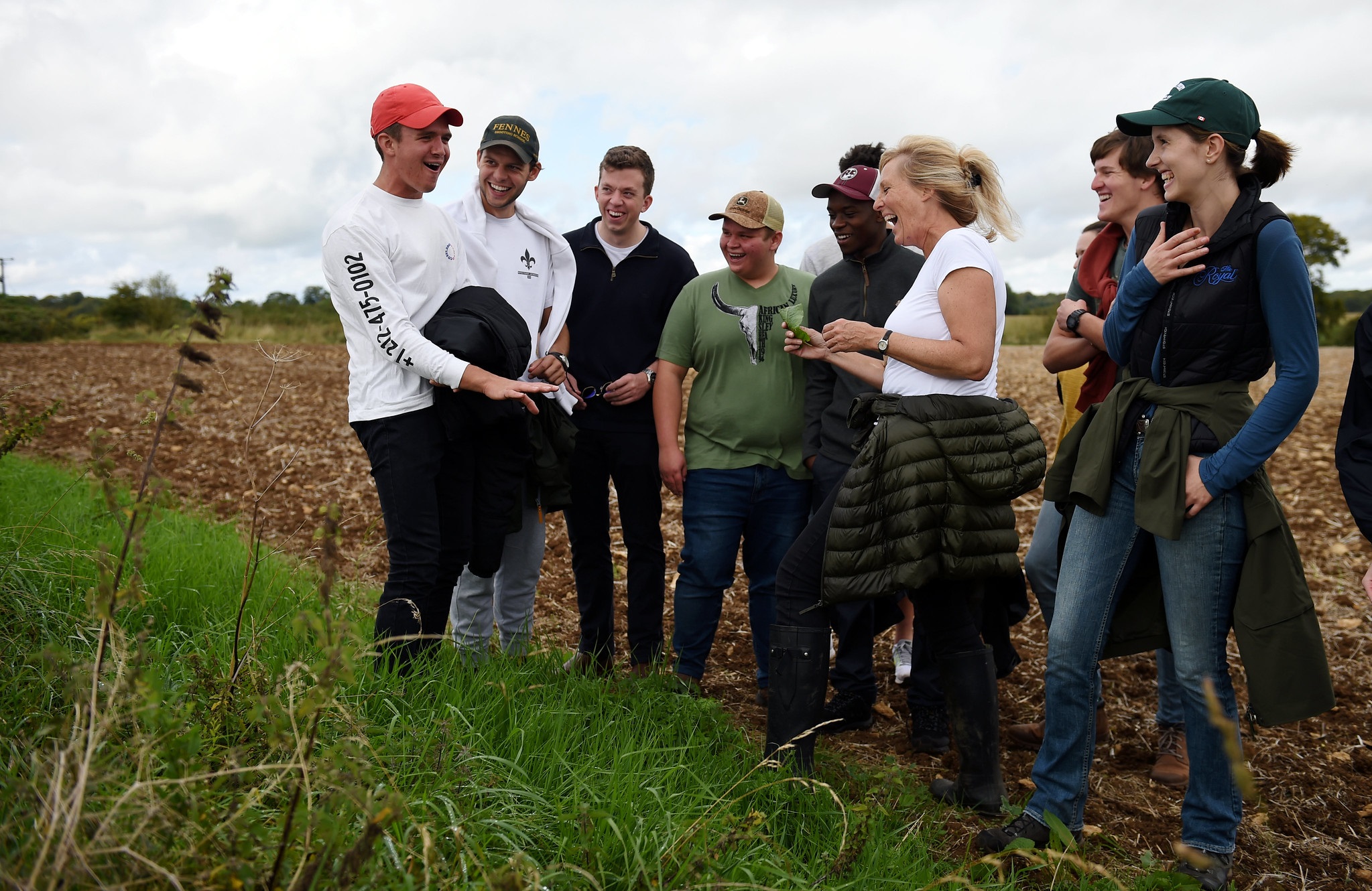 Group of international students looking at a plant