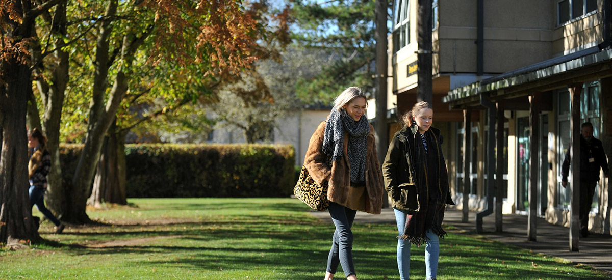 Two students walking on campus