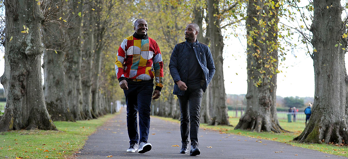 Two students walking down the driveway