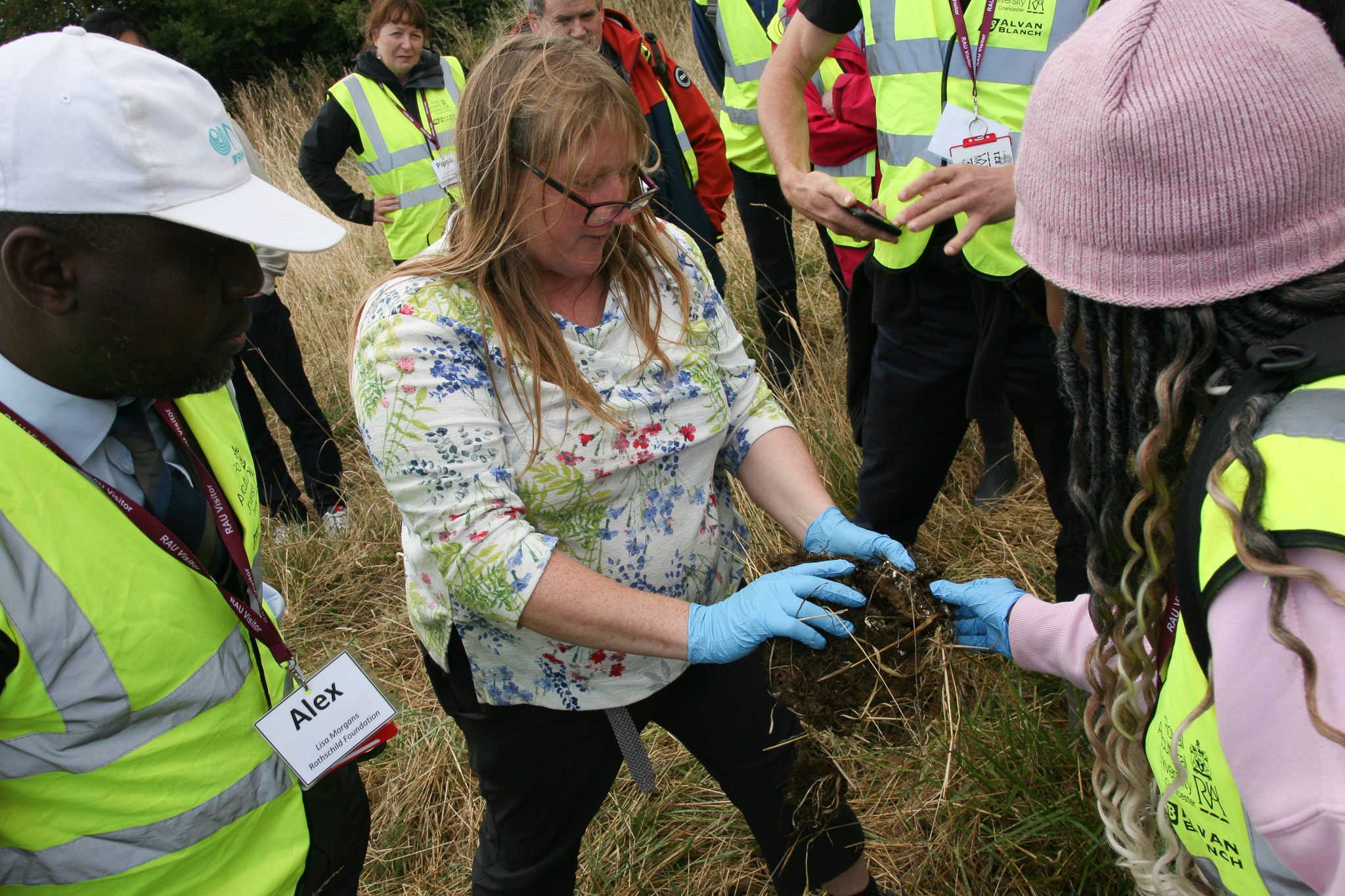 farmer holding up soil for delegates to observe