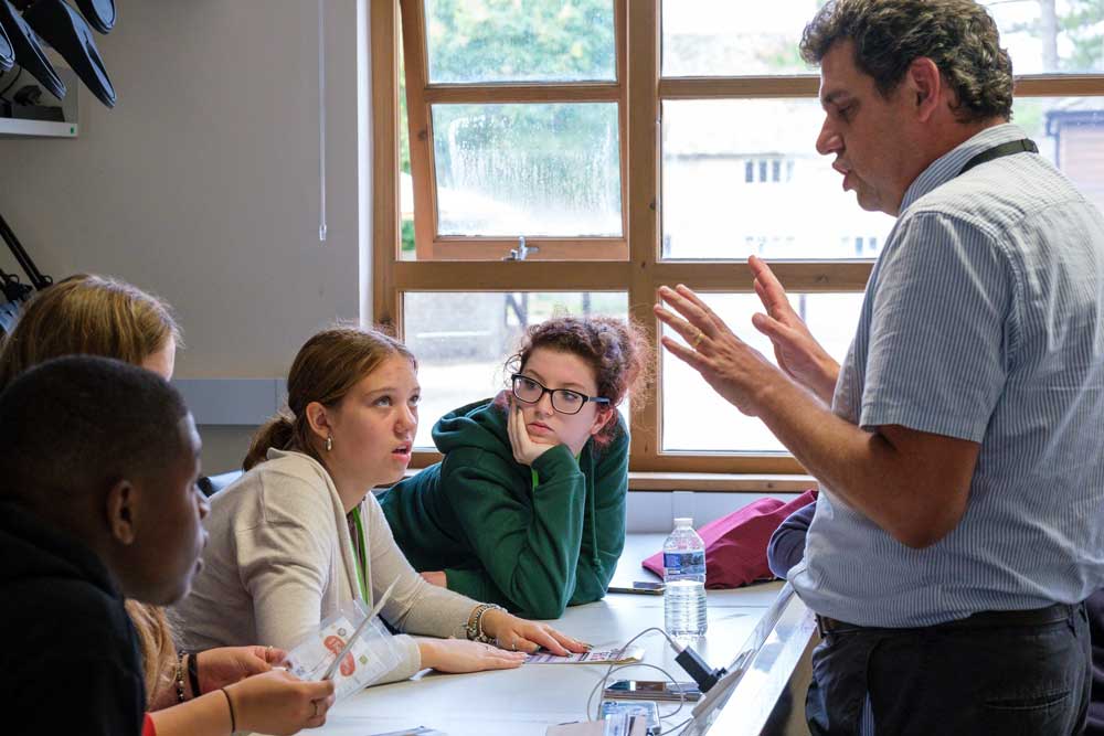 Lecturer teaching a group of teenagers