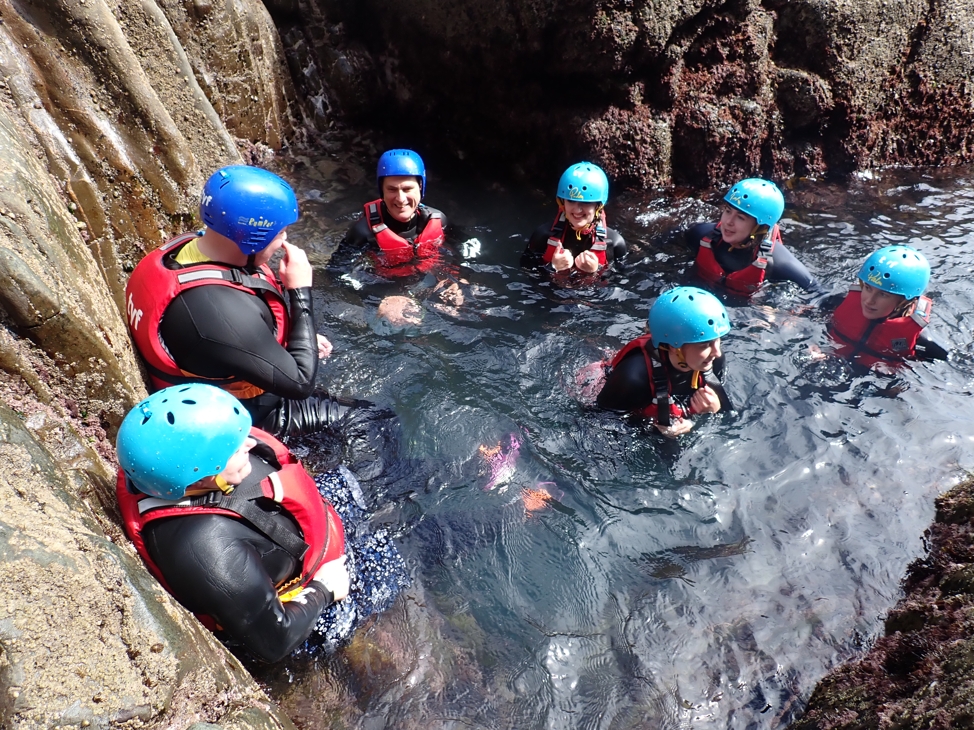 Future Leaders Programme delegates in running water on residential with life jackets and helmets