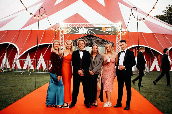 Group of students at May ball in front of a big top