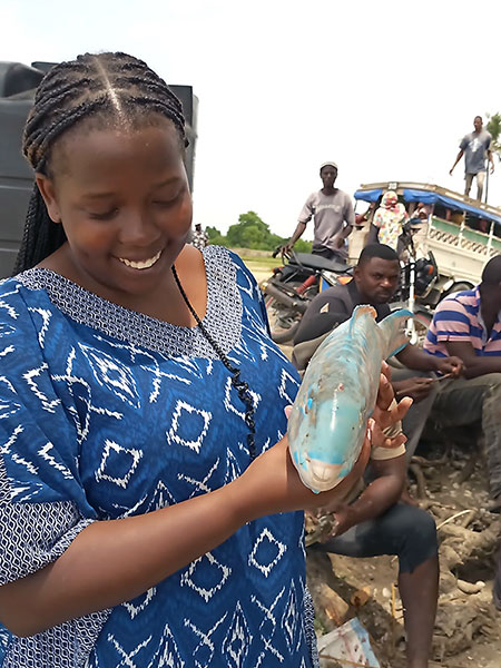 Neema holding a fish