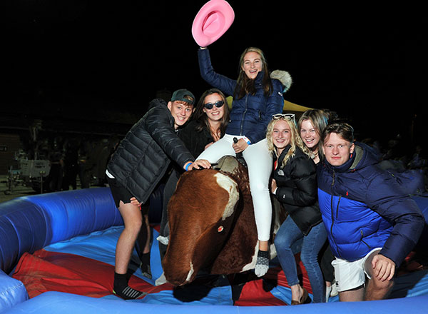 A group of students with a rodeo horse