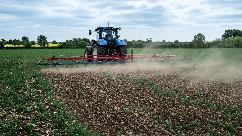 Image of a tractor raking the ground
