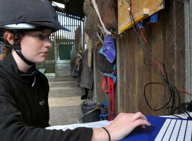 Equine student sitting at laptop