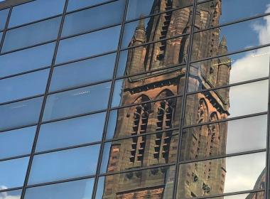 Church reflected in glass building