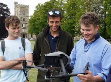 Students holding a drone