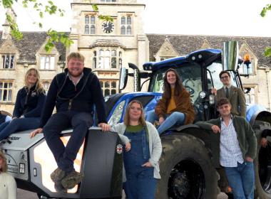 Kaleb Cooper and RAU students on a tractor