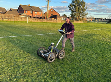 Henry Webber using ground survey equipment