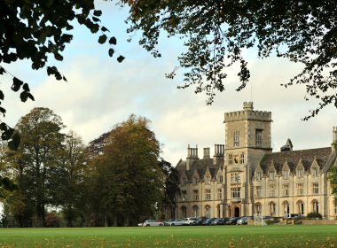 Royal Agricultural University main building front view from under trees